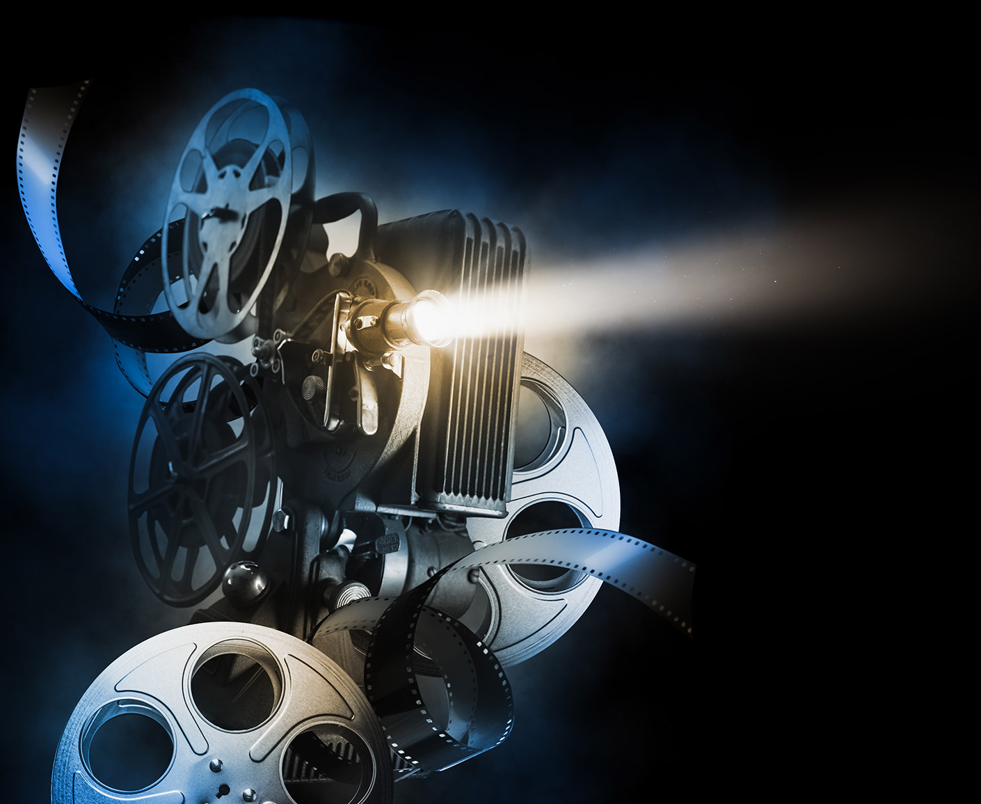 Artistic, stylized arrangement of film projection equipment and several film reels